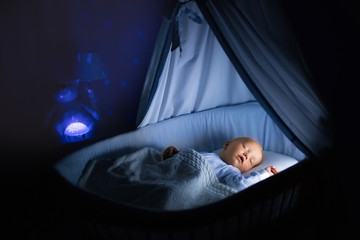 Baby boy drinking milk in bed