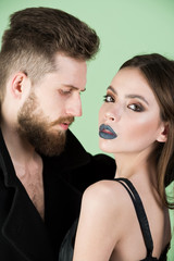 couple of bearded man, woman in black with fashionable makeup