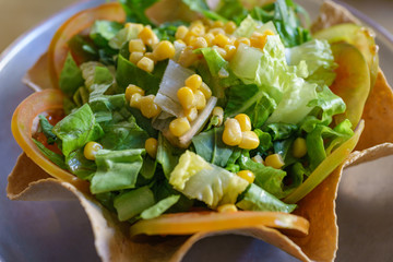 Healthy green vegetable salad with corn and tomato on crispy italian wontons