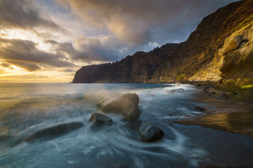 Fototapeta na wymiar Dynamic and dramatic sunset over Los Gigantes Cliffs in Tenerife