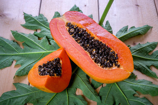 sweet papaya fruit on wooden background.
