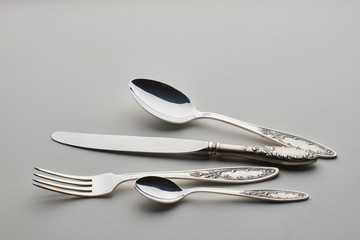 Cutlery. Set with fork, knife and spoons on gray background