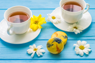 Still life with cup of tea and cake on the wooden background