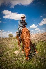 Cowboy riding a horse over the mountains - 146737593