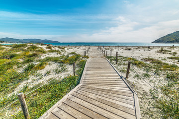 wooden boardwalk in Porto Giunco beach
