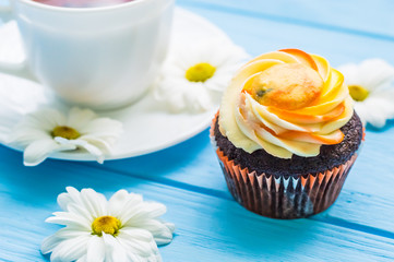 Still life with cup of tea and cake on the wooden background
