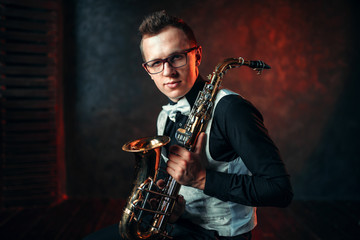 Fototapeta na wymiar Male saxophonist with saxophone, jazz man with sax