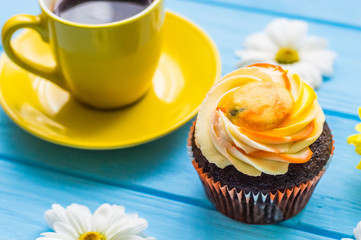 Still life with cup of tea and cake on the wooden background