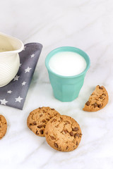 Chocolate chips cookies with milk glass and jar