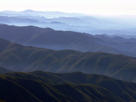 Saddleback mountain hills and valleys with haze