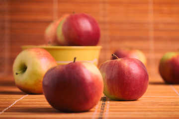 A scattering of apples on a wooden table