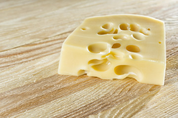 Lying on a wooden table cheese