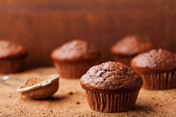 Chocolate banana muffin on brown rustic background. Delicious homemade bakery.
