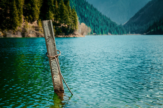 Majestic blue mountain lake with green trees