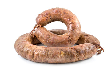 Two rings of homemade sausage on a white background.