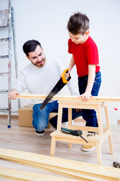 Father and son with saw