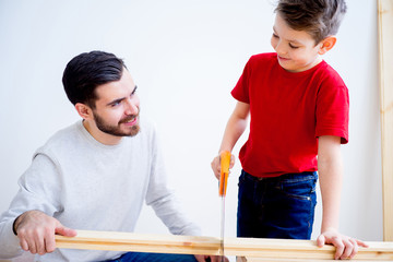 Father and son with saw