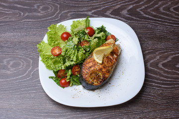 Deliciously cooked salmon with a salad on a plate