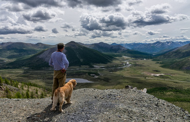 a man and a dog looking into the river valley - Powered by Adobe