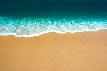Fototapeta na wymiar Wave of the sea on the sand beach background