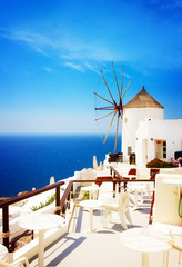 Windmill and blue Aegan sea at Oia, Santorini, Greecer, retro toned