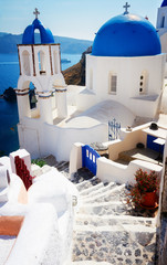 steep stairs and classical church with blue domes at sunny days , Oia, Santorini, Greecer, retro toned