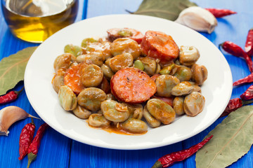 beans with smoked sausages on white dish