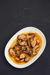 mussels in sauce on white dish