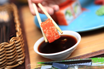 Person holding sushi