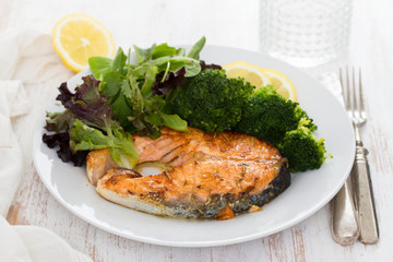 fried salmon with broccoli on dish