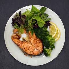 fried salmon with broccoli on dish