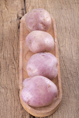 Pile of Colombian potato on wood