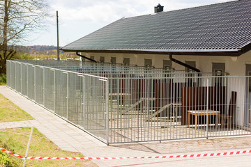 Outdoor dog kennels outside a building. - 146793969