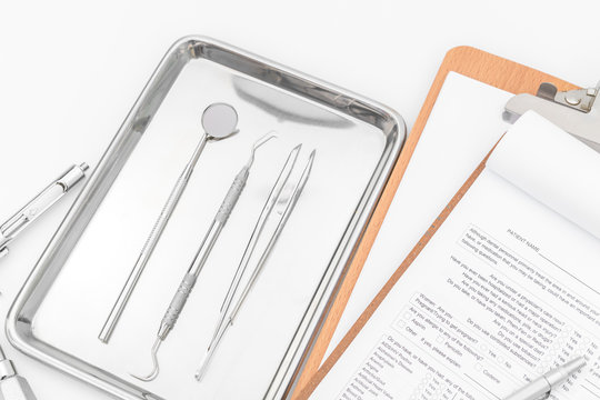 Dental tools, equipment and dental chart on white background
