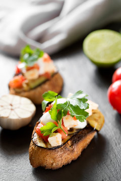 Tasty savory tomato Italian bruschetta, on slices of toasted baguette garnished with parsley