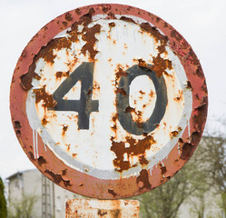A 40 km/h speed limit sign in a bad condition