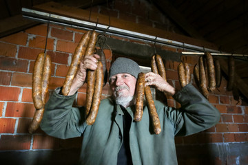 Old man with dry sausages
