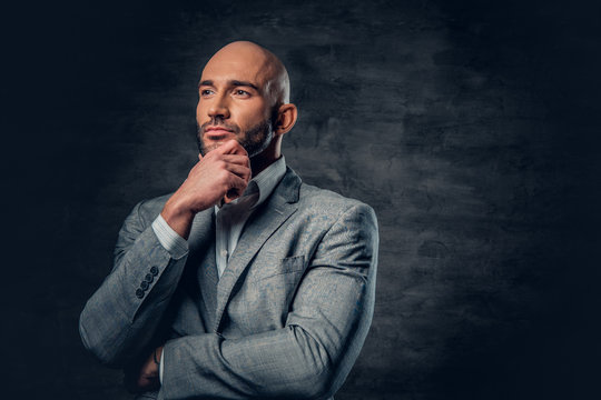 Positive Shaved Head Male Dressed In A Grey Suit.