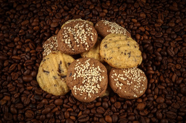 cookies on coffee beans background. Top view