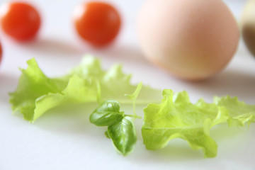Fresh organic free range eggs with cherry tomatoes. Food design isolated on white background. 