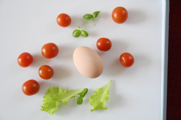 Fresh organic free range eggs with cherry tomatoes. Food design isolated on white background. 