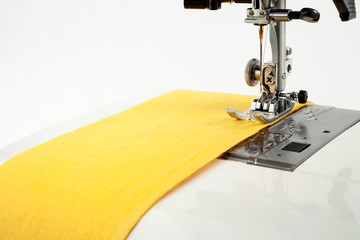 Sewing background. Sewing machine and fabric on a white background.