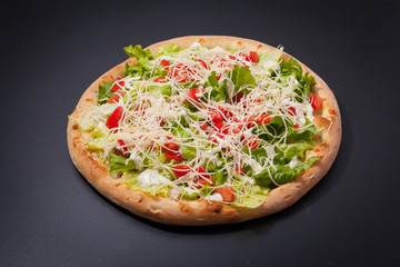 Pizza caesar on a matte black board