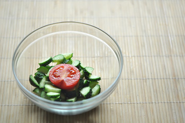 preparing vegetarian salad, a bowl of vegetables tomato and cucumber
