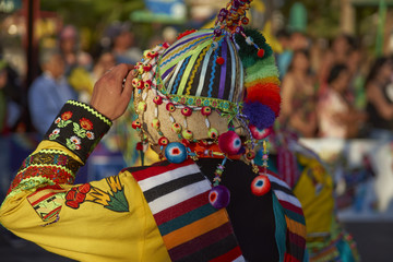 Tinkus Dance Group dressed in ornate costumes performing a traditional dance during a street parade...