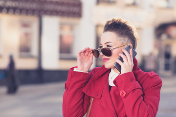 Girl model with phone on blurred background