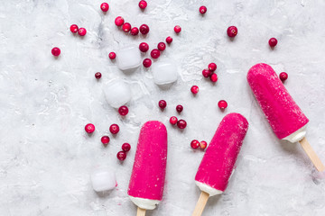 summer dessert with popsicle and red berries stone desk background top view