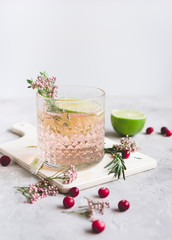 summer homemade juice with lime and berries on stone table background