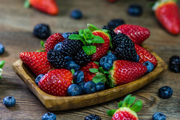 Mix Berries strawberries, blueberries, blackberries on Wooden Background. Summer Organic Berry over Wood. Agriculture, Gardening