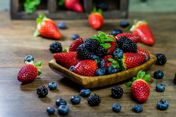 Mix Berries strawberries, blueberries, blackberries on Wooden Background. Summer Organic Berry over Wood. Agriculture, Gardening